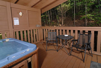 Pigeon Forge Cabint that is convenient to the main parkway that has a seating area located beside the hot tub